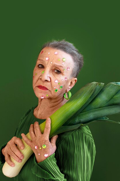 Medium shot senior woman posing with celery