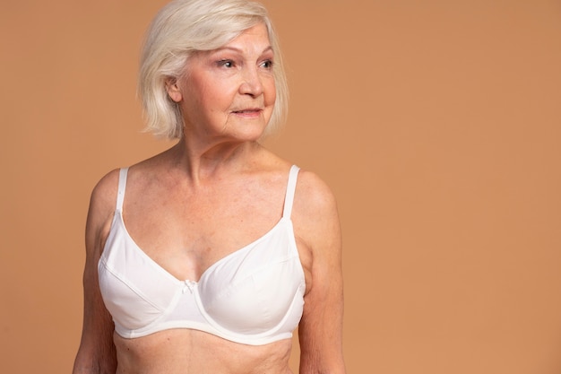 Senior woman with abundant big breasts in bra - Stock Photo