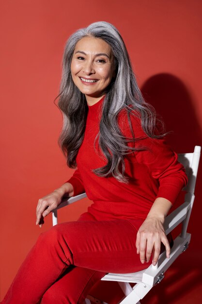 Medium shot senior woman sitting on chair