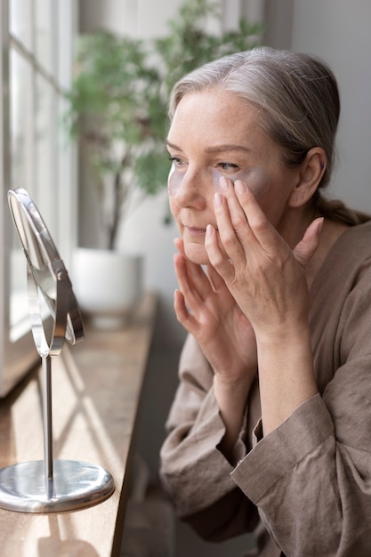 Free photo medium shot senior woman with eye patches