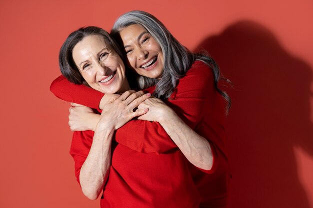 Medium shot senior women hugging