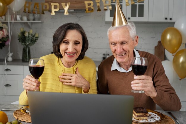 Foto gratuita anziani di tiro medio con bicchieri di vino