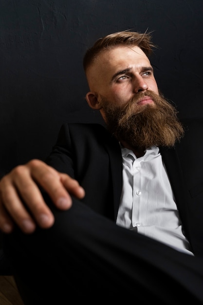 Free photo medium shot sensitive man posing in studio