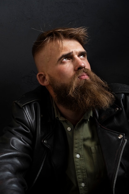 Free photo medium shot sensitive man posing in studio