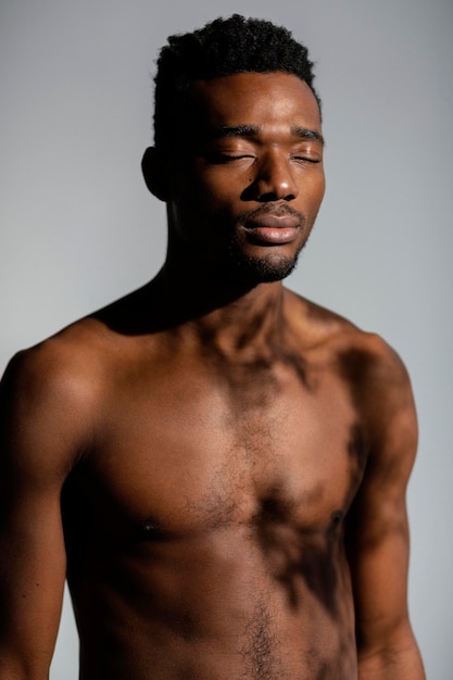 Medium shot shirtless man posing