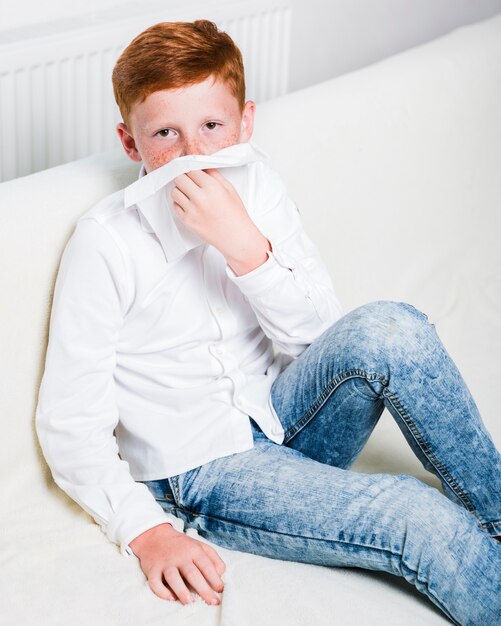 Medium shot sick boy on the sofa