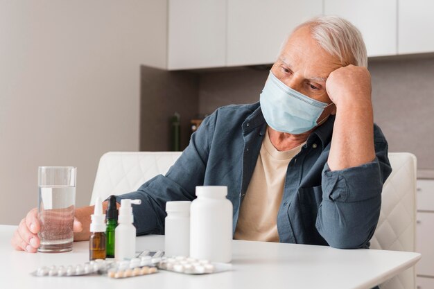 Medium shot sick man wearing medical mask