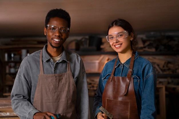 Foto gratuita artigiani di smiley a tiro medio in officina