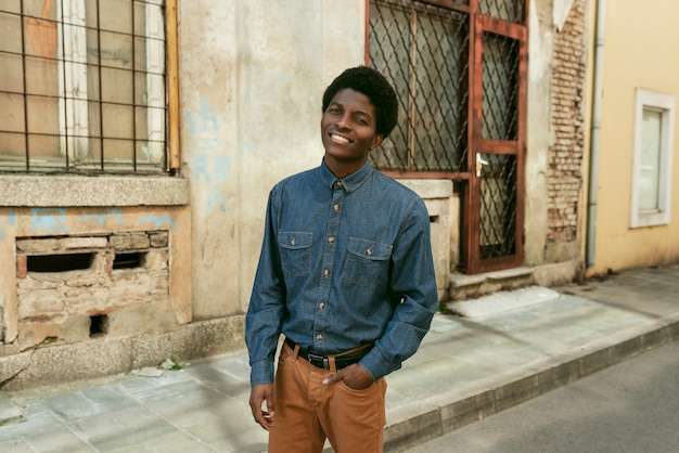 Medium shot smiley black man posing in the 70s