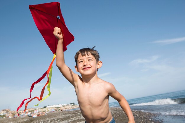 Medium shot smiley boy playing with kite