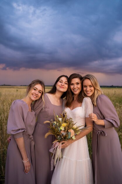 Medium shot smiley bride and bridesmaids