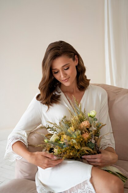 Medium shot smiley bride holding flowers