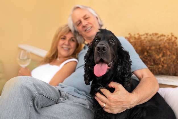 Free photo medium shot smiley couple adorable dog