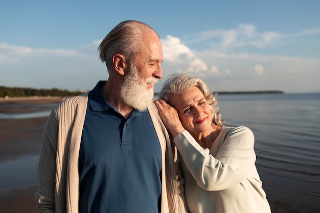 Medium shot smiley couple at beach