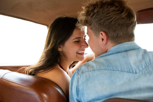 Medium shot smiley couple in car