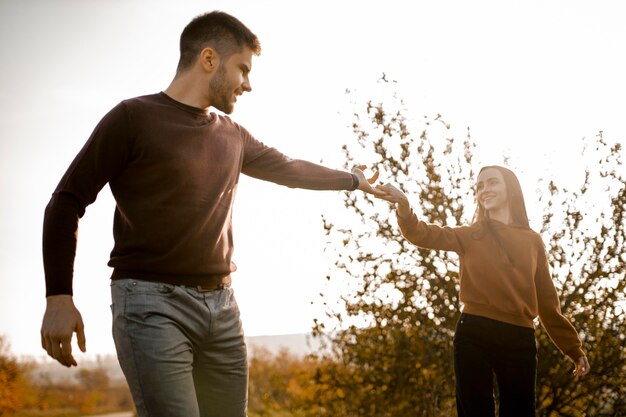 Medium shot smiley couple holding hands