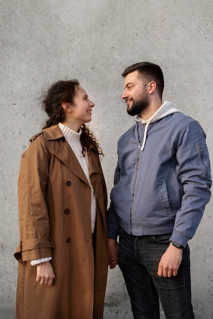 Medium shot smiley couple holding hands