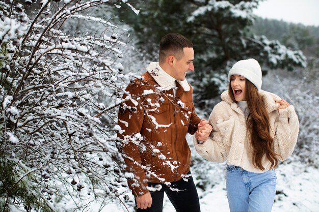 Medium shot smiley couple outdoors