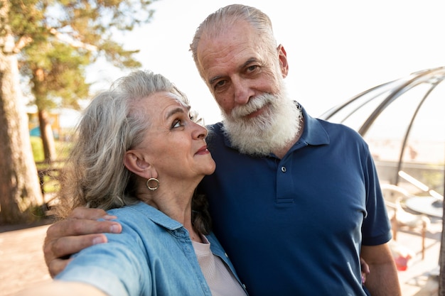 Medium shot smiley couple taking selfie