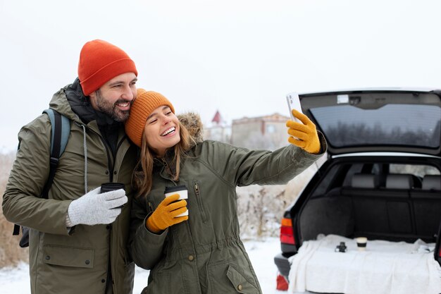 Medium shot smiley couple taking selfie