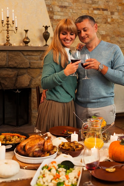 Free photo medium shot smiley couple toasting