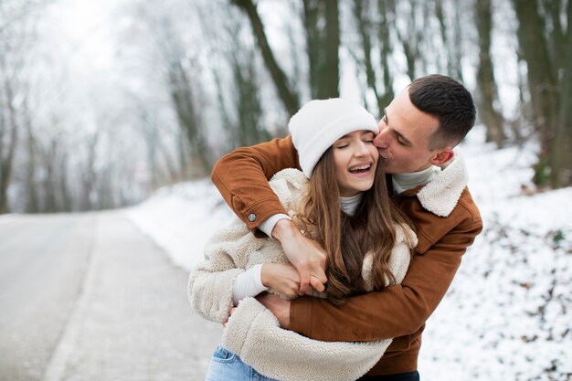 Medium shot smiley couple winter time