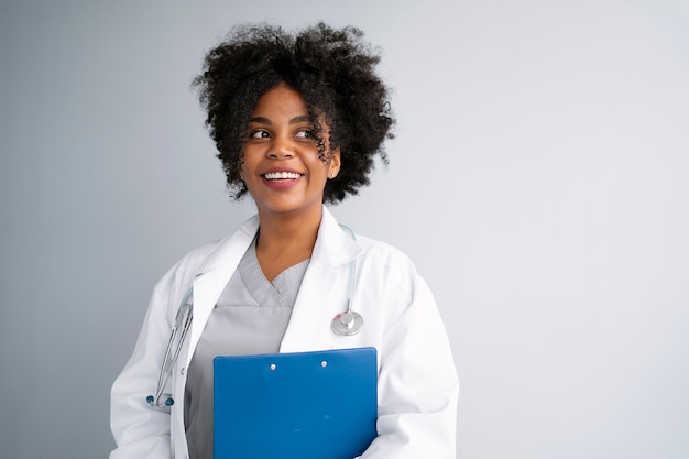 Medium shot smiley doctor with stethoscope