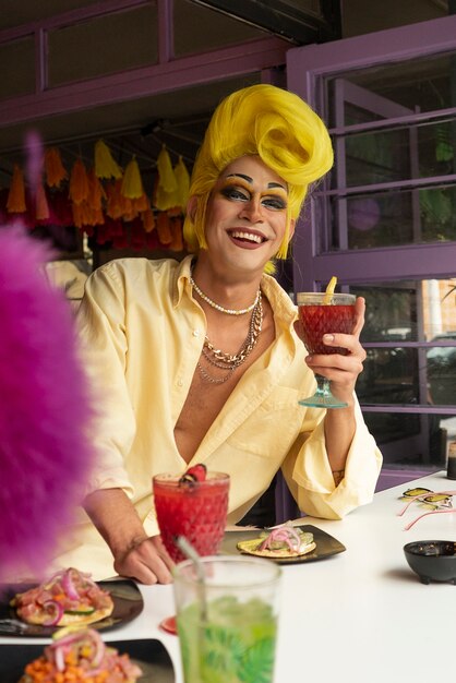 Medium shot smiley drag queen with drink