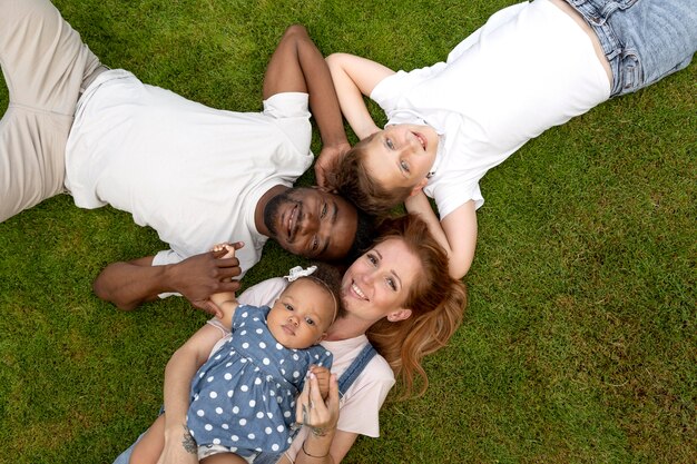 Medium shot smiley family on grass