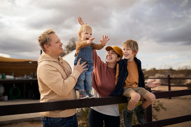 Medium shot smiley family outside