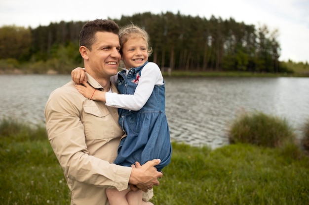 Medium shot smiley father holding kid