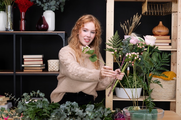 Free photo medium shot smiley florist with plants