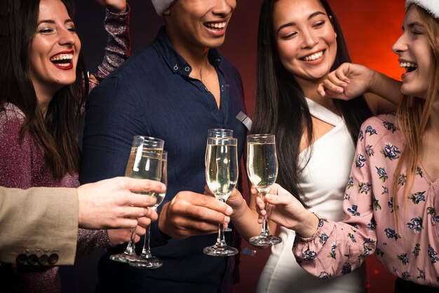 Medium shot of smiley friends toasting