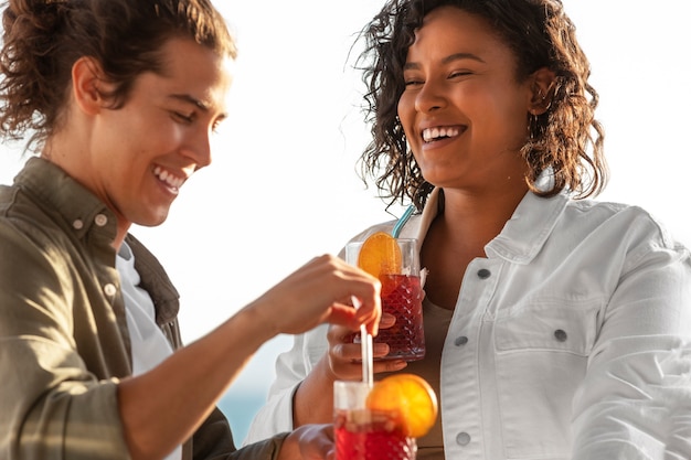 Amici sorridenti di scatto medio con gustosa sangria