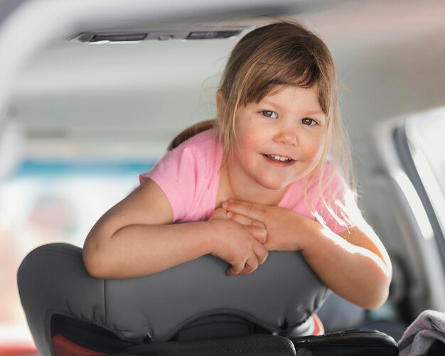 Medium shot smiley girl in car