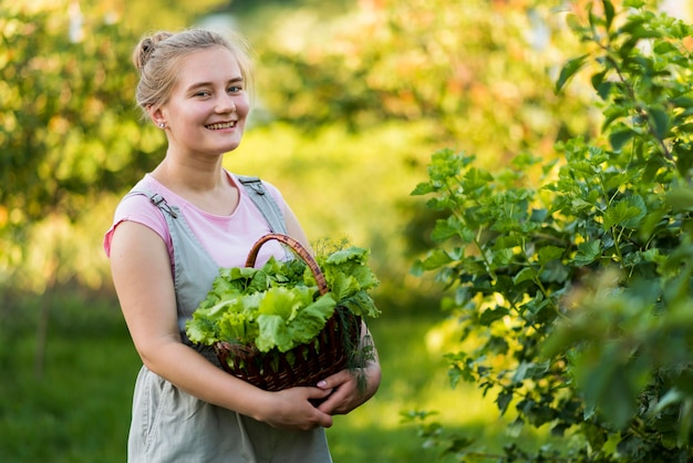 Medium shot smiley girl holding basket