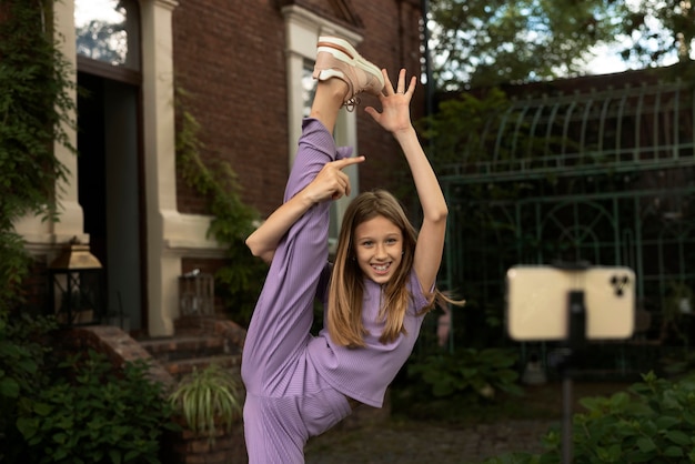 Medium shot smiley girl holding leg up