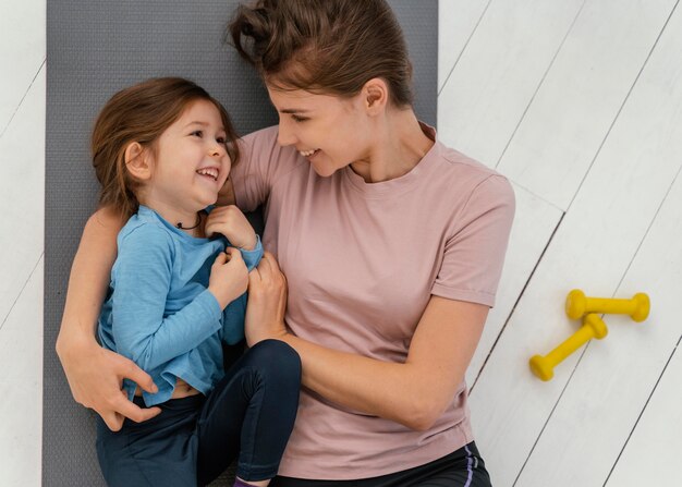 Medium shot smiley girl and mother