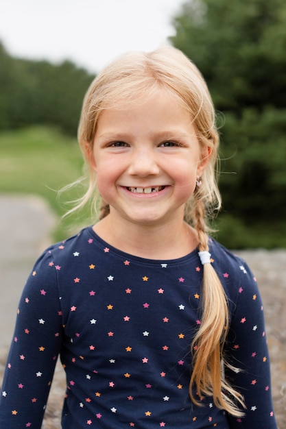 Medium shot smiley girl in nature