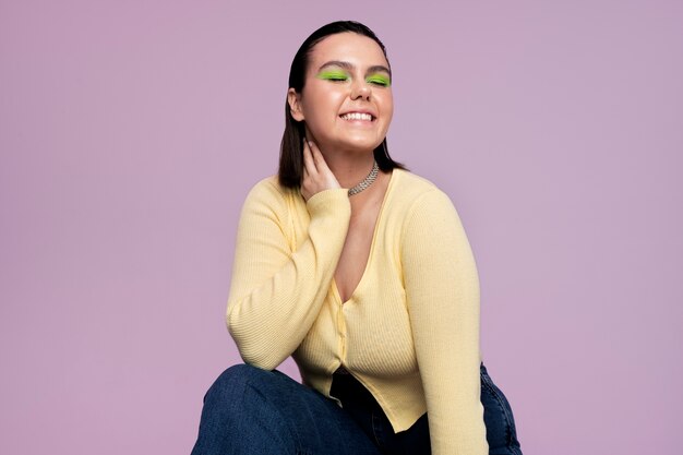 Medium shot smiley girl posing in studio