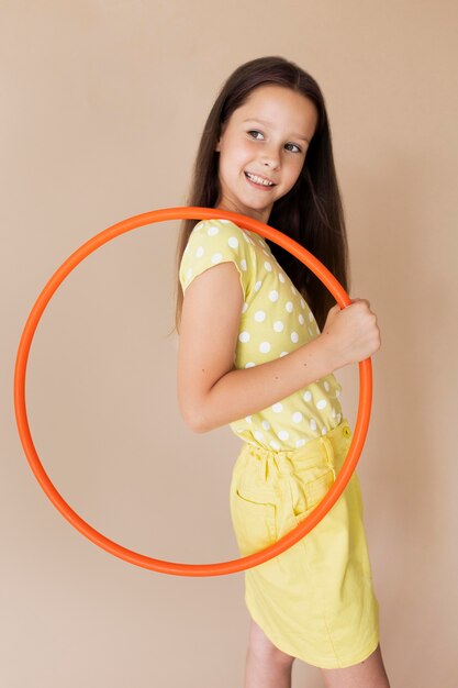 Medium shot smiley girl posing with circle