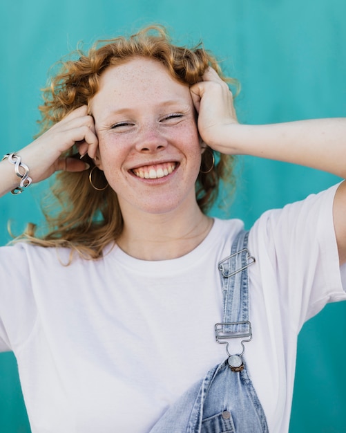 Medium shot smiley girl with blue background