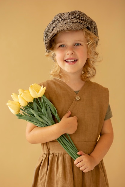 Medium shot smiley girl with flowers