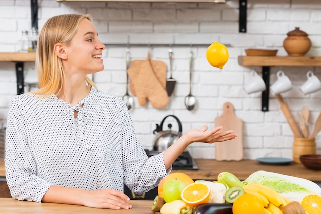 Medium shot smiley girl with fresh fruits