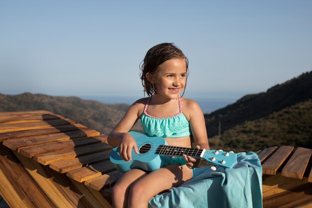 Medium shot smiley girl with guitar