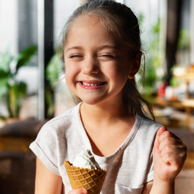 Medium shot smiley girl with ice cream