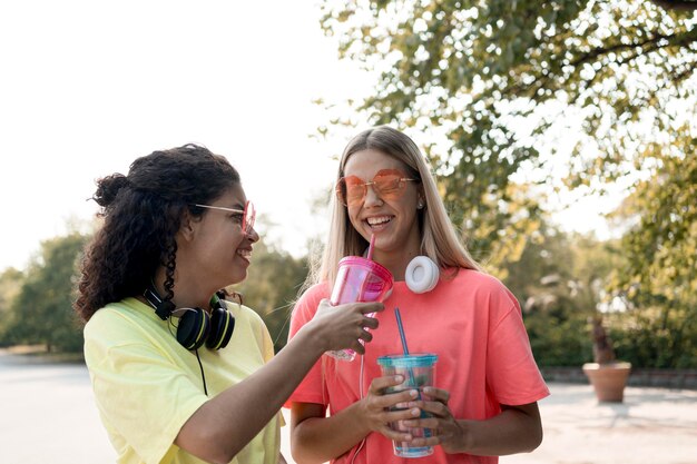 Medium shot smiley girls outdoors