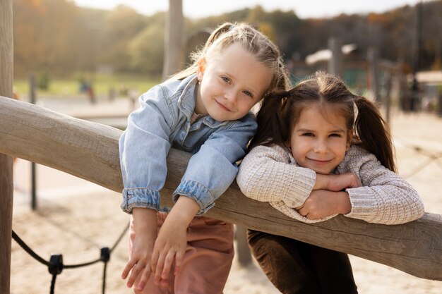 Medium shot smiley girls outdoors