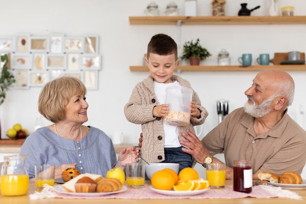 Free photo medium shot smiley grandparents and boy