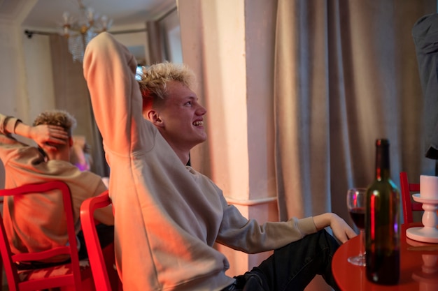 Medium shot smiley guy sitting at table